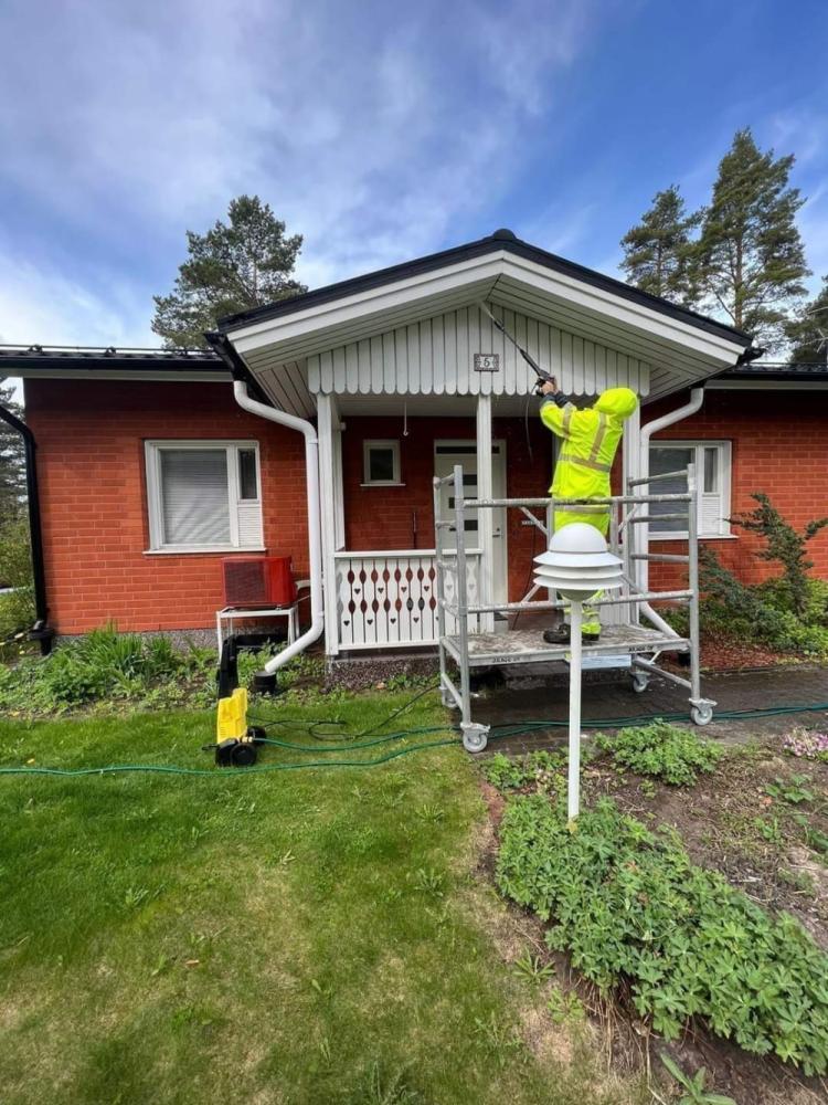 Omakotitalon räystäslautojen ja kuistin maalaus.